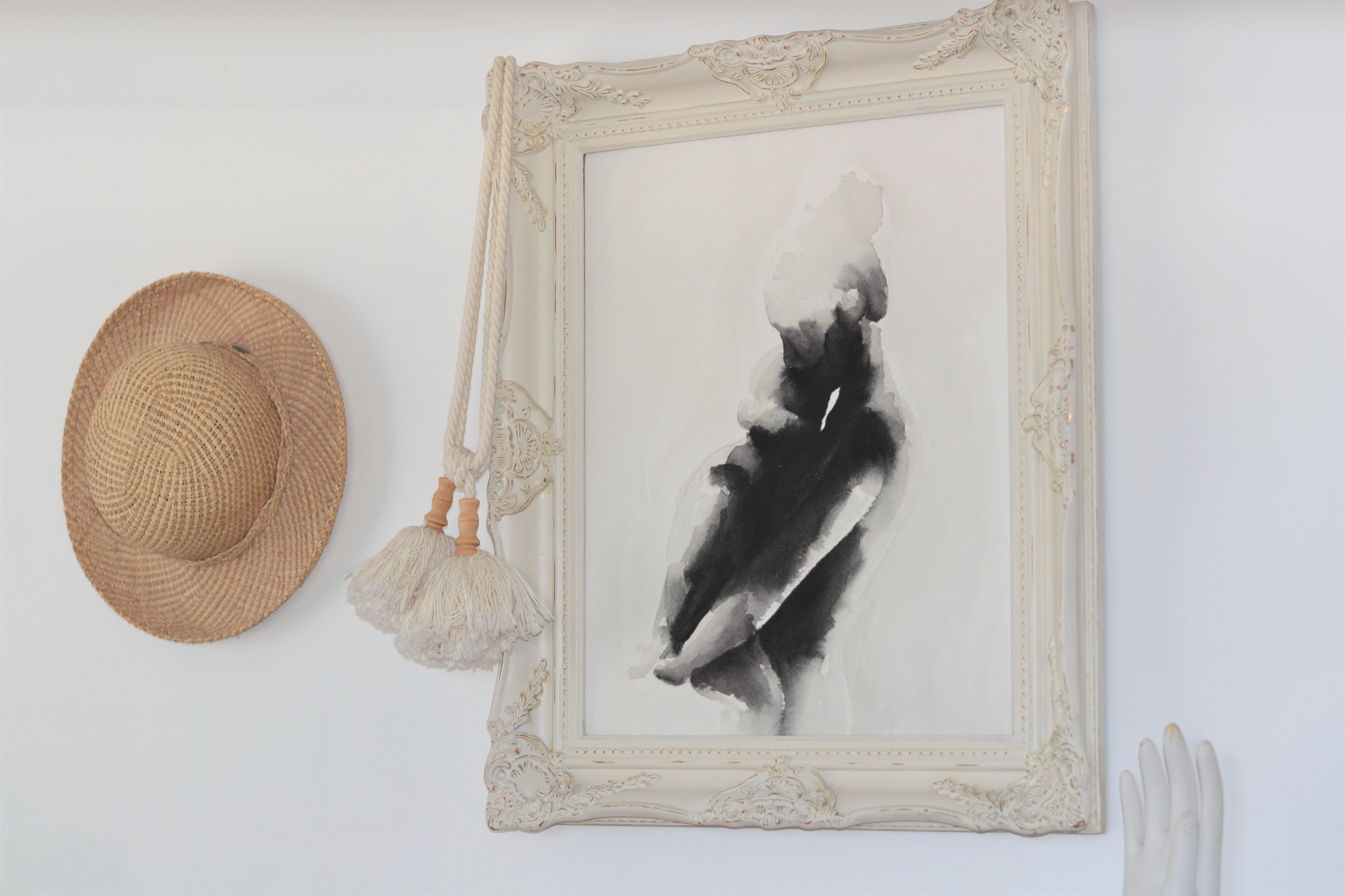Thrifted frame and everyday hats as decor